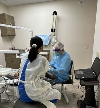 An image of Dr. Kan working on a patient